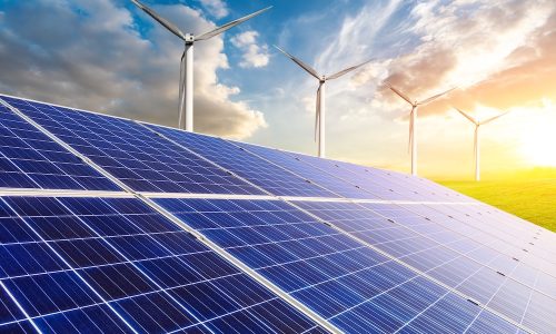 Solar panels with wind turbines in the setting sun,green energy.